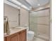 Clean bathroom, shower, toilet and wooden vanity at 3408 Founders Club Dr, Sarasota, FL 34240