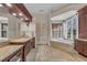 Luxurious bathroom with vanity, soaking tub, and large windows with natural light and elegant finishes at 3408 Founders Club Dr, Sarasota, FL 34240