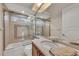 Bathroom with a walk-in shower, glass door, tiled walls, and vanity at 3408 Founders Club Dr, Sarasota, FL 34240