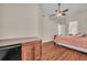 Bedroom featuring a beverage cooler, wood floors, and a ceiling fan at 3408 Founders Club Dr, Sarasota, FL 34240