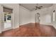 Bright bedroom with wood floors, a ceiling fan, and access to the outdoor patio area at 3408 Founders Club Dr, Sarasota, FL 34240