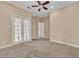 Bedroom with carpet flooring and double doors at 3408 Founders Club Dr, Sarasota, FL 34240