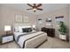 Comfortable bedroom with decorative pillows, a ceiling fan, and matching nightstands at 3408 Founders Club Dr, Sarasota, FL 34240
