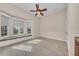 Bedroom features a bay window with a bench seat, tile floors, and a ceiling fan at 3408 Founders Club Dr, Sarasota, FL 34240