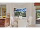 Cozy breakfast nook with a view of the screened-in pool area and lush landscaping at 3408 Founders Club Dr, Sarasota, FL 34240