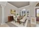 Elegant dining room featuring a large window and a chandelier over the dining table at 3408 Founders Club Dr, Sarasota, FL 34240