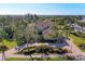 Expansive home with a brick driveway and manicured lawn, viewed from above at 3408 Founders Club Dr, Sarasota, FL 34240