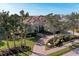 Aerial view of home with brick driveway and lush landscaping at 3408 Founders Club Dr, Sarasota, FL 34240