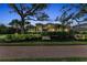Stunning exterior of the home showcasing lush landscaping and a clay tile roof at 3408 Founders Club Dr, Sarasota, FL 34240