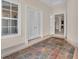 Bright foyer with tiled floor, large window, and elegant French doors leading to other rooms at 3408 Founders Club Dr, Sarasota, FL 34240