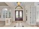 Grand foyer featuring a decorative ceiling, arched windows, and double front doors at 3408 Founders Club Dr, Sarasota, FL 34240