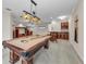 Spacious game room with a billiard table, wooden bar, and custom built-in cabinets at 3408 Founders Club Dr, Sarasota, FL 34240