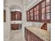 Hallway with granite countertops, dark wood cabinetry, and a wine refrigerator at 3408 Founders Club Dr, Sarasota, FL 34240