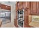 Modern kitchen with stainless steel appliances including built-in ovens and custom cabinets at 3408 Founders Club Dr, Sarasota, FL 34240