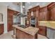 Gourmet kitchen featuring a large island, stainless steel appliances, and custom wood cabinetry at 3408 Founders Club Dr, Sarasota, FL 34240