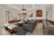 Cozy living room with neutral tones, ceiling fan, and adjacent kitchen and bar at 3408 Founders Club Dr, Sarasota, FL 34240