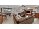 Comfortable living room featuring a leather sofa, pool table, and built-in wooden entertainment center at 3408 Founders Club Dr, Sarasota, FL 34240