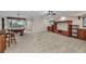 Open living space with a pool table, a bar, carpeted flooring, and custom built-in cabinets at 3408 Founders Club Dr, Sarasota, FL 34240