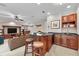 Living area with a granite countertop wet bar, wooden stools, and built-in shelving at 3408 Founders Club Dr, Sarasota, FL 34240