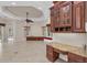 Open-concept living area with custom cabinetry, a built-in desk, and views of the surrounding landscape at 3408 Founders Club Dr, Sarasota, FL 34240