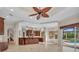 Spacious open-concept living space with access to the kitchen and outdoor pool area at 3408 Founders Club Dr, Sarasota, FL 34240
