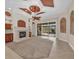 Spacious living room with a fireplace, unique ceiling design, and access to the outdoor pool area at 3408 Founders Club Dr, Sarasota, FL 34240