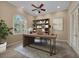 Bright office featuring a large desk, built-in shelving, and a window with natural light at 3408 Founders Club Dr, Sarasota, FL 34240