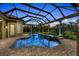 The pool and integrated hot tub is beautifully lit for evening relaxation at 3408 Founders Club Dr, Sarasota, FL 34240