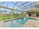 Resort-style pool and spa with covered patio offering scenic views at 3408 Founders Club Dr, Sarasota, FL 34240