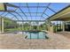 Covered patio with pool, spa, and view of lush landscaping at 3408 Founders Club Dr, Sarasota, FL 34240