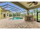 Relaxing pool and spa with covered patio and fireplace at 3408 Founders Club Dr, Sarasota, FL 34240