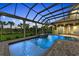 Enclosed pool and spa area with a covered patio at 3408 Founders Club Dr, Sarasota, FL 34240