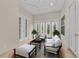 Bright sunroom with comfortable seating and access to the outdoors at 3408 Founders Club Dr, Sarasota, FL 34240