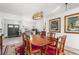 Sunlit dining room with hardwood table and chairs, and red rug at 4028 Dover E Dr, Bradenton, FL 34203