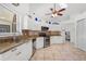 Modern kitchen with granite countertops, stainless steel appliances, and white cabinets at 4028 Dover E Dr, Bradenton, FL 34203