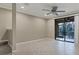 Living room with tile floor, neutral walls, and sliding glass doors leading to a patio at 4207 Overture Cir, Bradenton, FL 34209