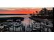 Sunset view of several boats docked at a marina at 4500 Gulf Of Mexico Dr # 205, Longboat Key, FL 34228