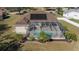 House with solar panels, a screened pool, and lush landscaping at 4569 35Th Avenue E Cir, Palmetto, FL 34221