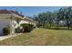 Large backyard with expansive lawn and mature trees beside house at 4569 35Th Avenue E Cir, Palmetto, FL 34221