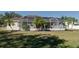 Backyard view of house with screened patio and palm trees at 4569 35Th Avenue E Cir, Palmetto, FL 34221