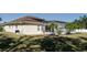 Home's back exterior, showcasing a large backyard and screened enclosure at 4569 35Th Avenue E Cir, Palmetto, FL 34221