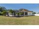 Home's back exterior, showing a large backyard and screened enclosure at 4569 35Th Avenue E Cir, Palmetto, FL 34221