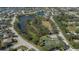 An aerial view of a residential community with a lake, playground, and tennis court at 4569 35Th Avenue E Cir, Palmetto, FL 34221