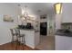 Modern kitchen with light wood cabinets and a breakfast bar at 4569 35Th Avenue E Cir, Palmetto, FL 34221