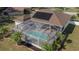 Enclosed pool with surrounding landscaping at 4569 35Th Avenue E Cir, Palmetto, FL 34221