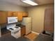 Kitchen with wood cabinets, appliances, and flooring at 4802 51St W St # 421, Bradenton, FL 34210