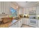 White kitchen with granite countertops and stainless steel appliances at 530 Freeling Dr, Sarasota, FL 34242