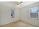 Simple bedroom with two windows and ceiling fan at 5365 Matthew Ct, Sarasota, FL 34231