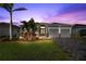 Two-story house with gray exterior, landscaping, and a paved driveway at 5485 56Th E Ct, Bradenton, FL 34203