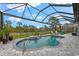 Inviting freeform pool with a screened enclosure, surrounded by a paved patio at 5485 56Th E Ct, Bradenton, FL 34203